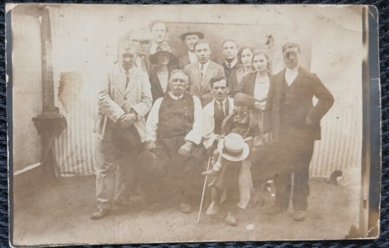 Fotografie tip Carte Postala, Grup de barbati si femei la Haramul bisericii din satul Duinigi judetul Constanta, 1924