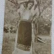 Fotografie tip Carte postala, Tanara in costum traditional, in livada, perioada interbelica